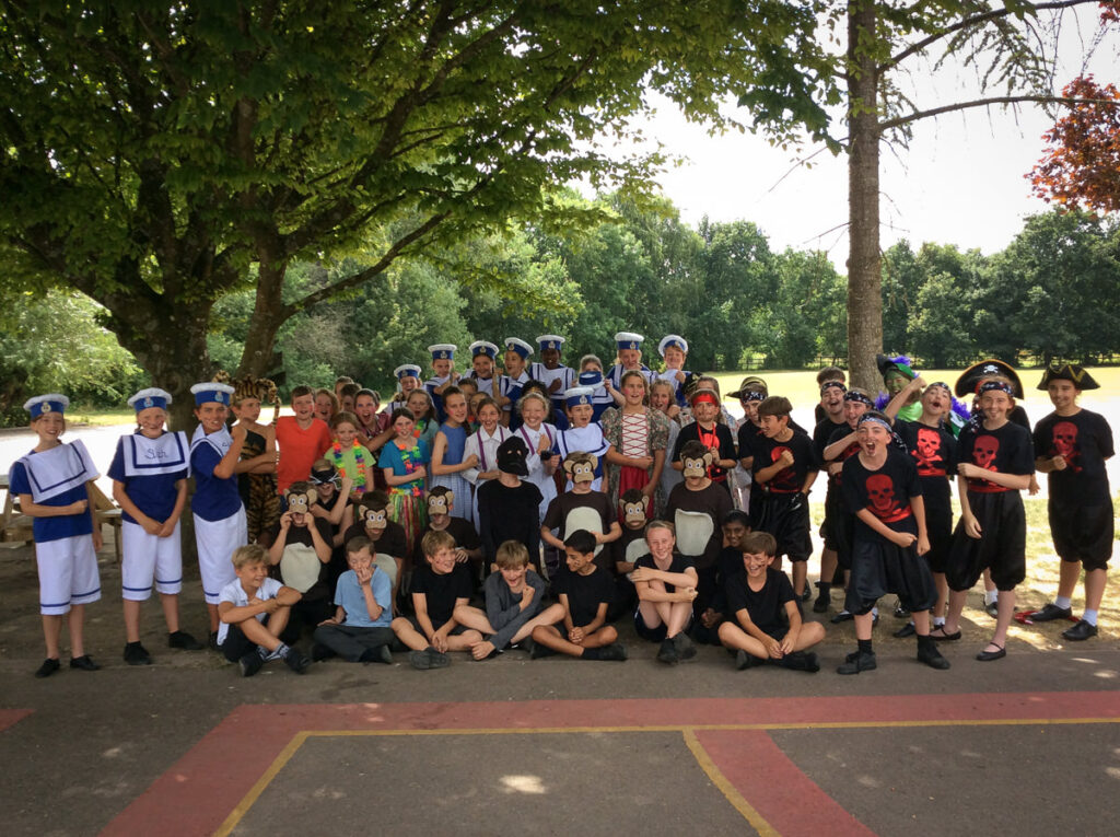 Cast photo of a group of children in costume for a play